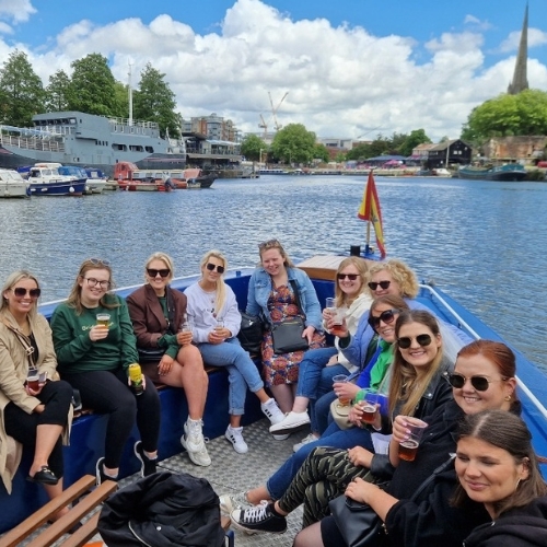 Guests aboard HMS Hops, the private ferry on Bristol's Floating Harbour, tasting beer
